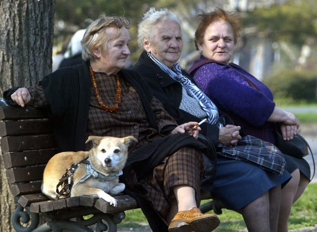 <p>Three elderly women with a pet rest on a bank in a park in central Belgrade, 07 April 2005 as they take advantage of nice weather over the region</p>