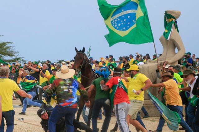 <p>A Military Police officer falls from his horse during clashes with supporters of Brazilian former President Jair Bolsonaro after an invasion to Planalto Presidential Palace in Brasilia</p>