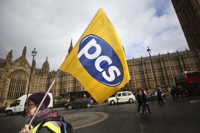 Demonstrators from the Public and Commercial Services union protest outside the Houses of Parliament in London (Philip Toscano/PA)