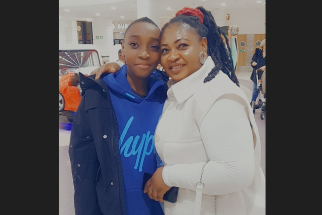 <p>Rosina, here with her 12-year-old son Jesse, has been unable to leave the country due to Home Office delays </p>