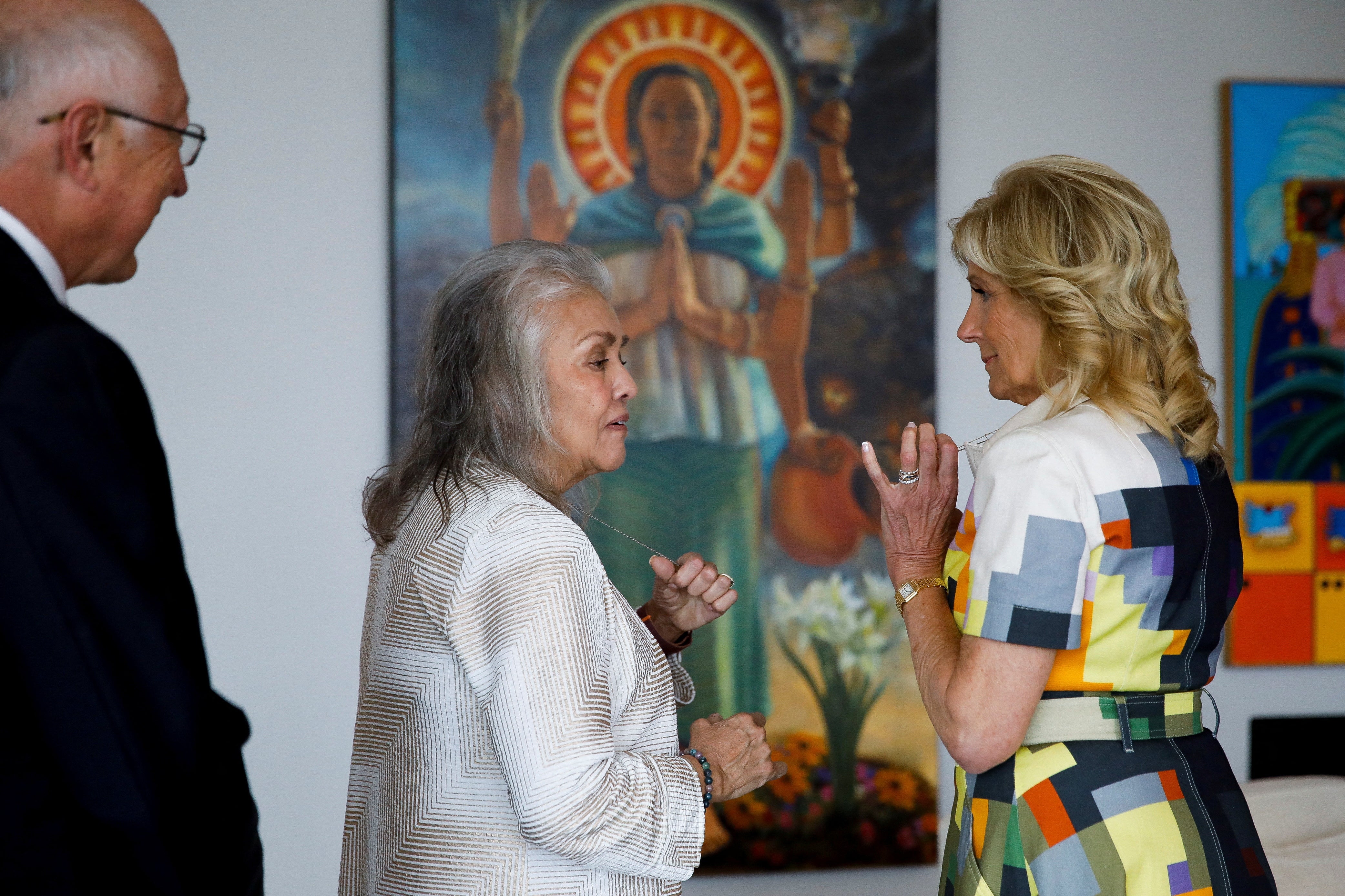 Jill Biden speaks with Hope Salazar, wife of US Ambassador to Mexico Ken Salazar, as they tour around the house to view paintings at the ambassador’s residence in Mexico City