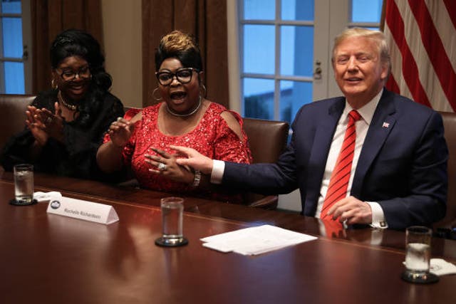 <p>Donald Trump listens as Lynette ‘Diamond’ Hardaway and Rochelle ‘Silk’ Richardson praise him during a news conference and meeting with African American supporters in the Cabinet Room at the White House 27 February 2020 </p>