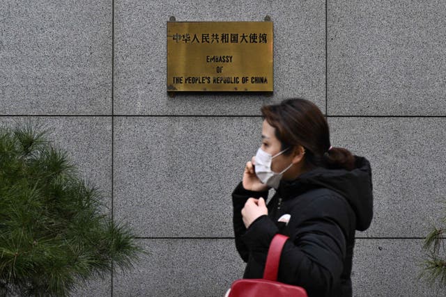 <p>A pedestrian walks outside the Chinese embassy in Seoul on Tuesday </p>