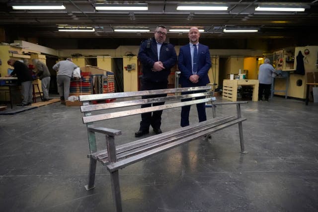 Chief officer Brian Cahill and assistant Governor David Mulligan pictured with some of the furniture made in the Mountjoy prison Men’s Shed (Niall Carson/PA)