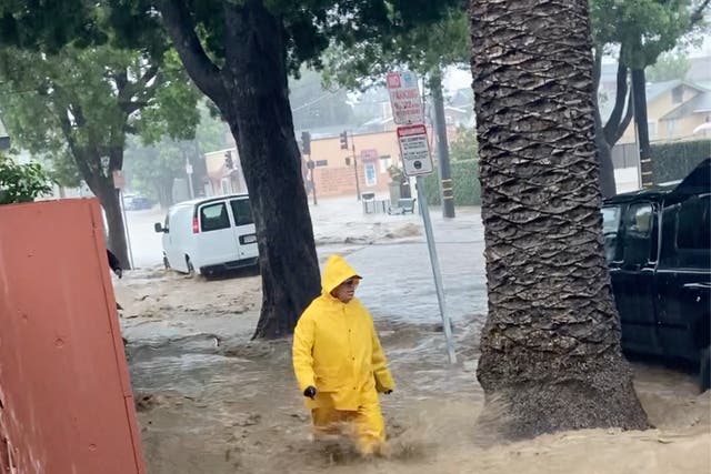 <p>A person wades through streaming flood water, in Santa Barbara, California on January 9, 2023</p>