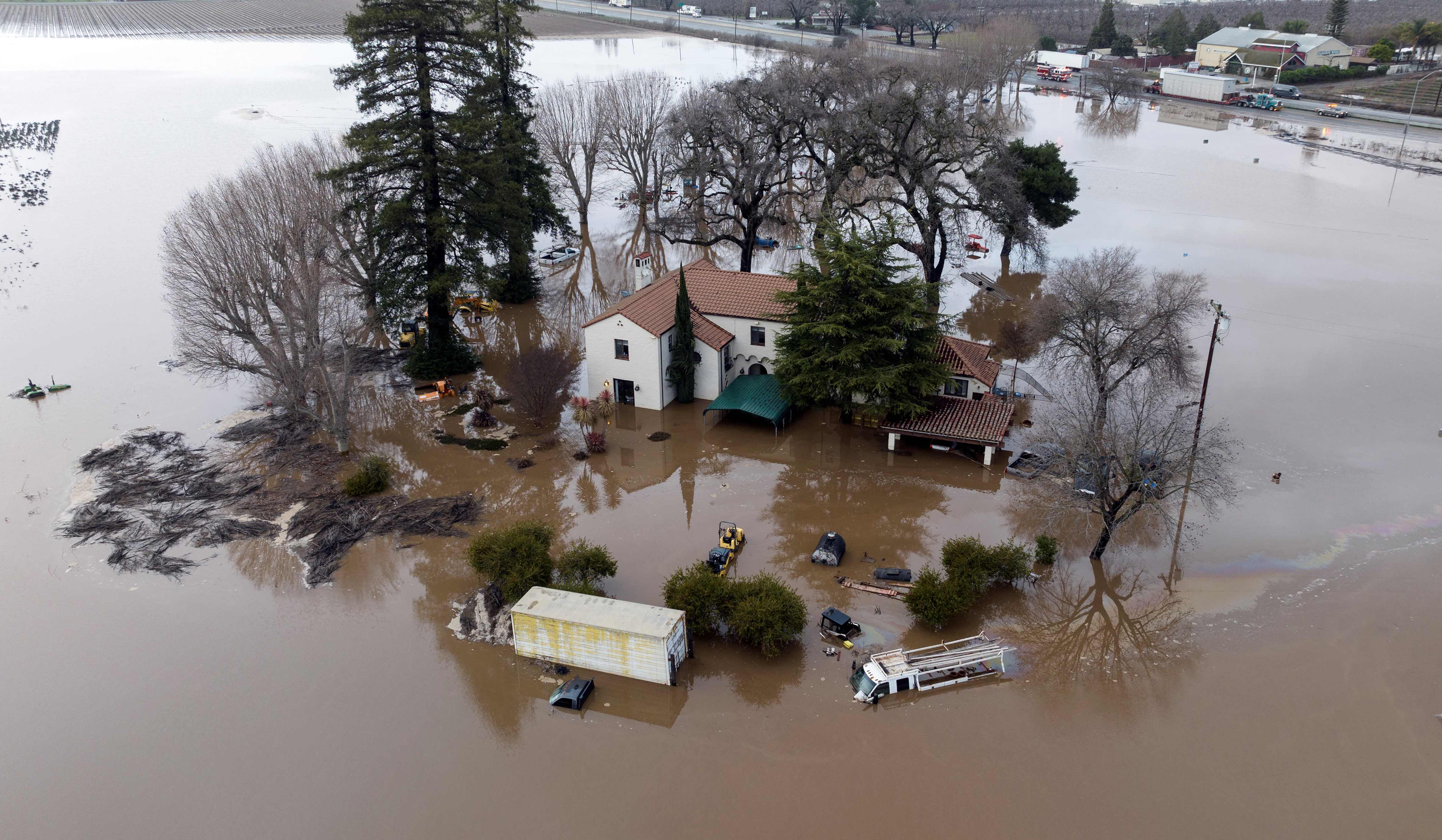 This aerial view shows a flooded home partially underwater in Gilroy, California, on January 9, 2023