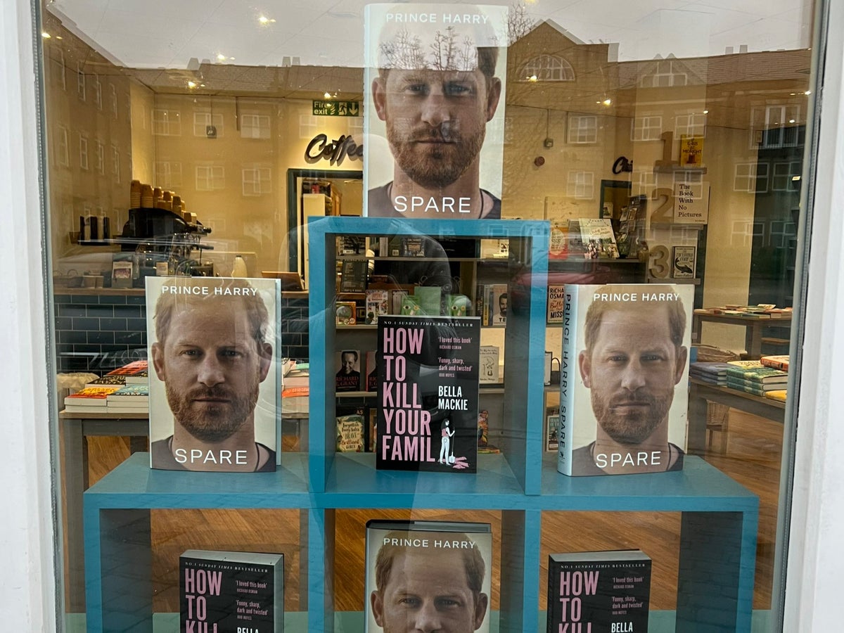 ‘Spare’ by Prince Harry displayed next to ‘How To Kill Your Family’ in bookstore window