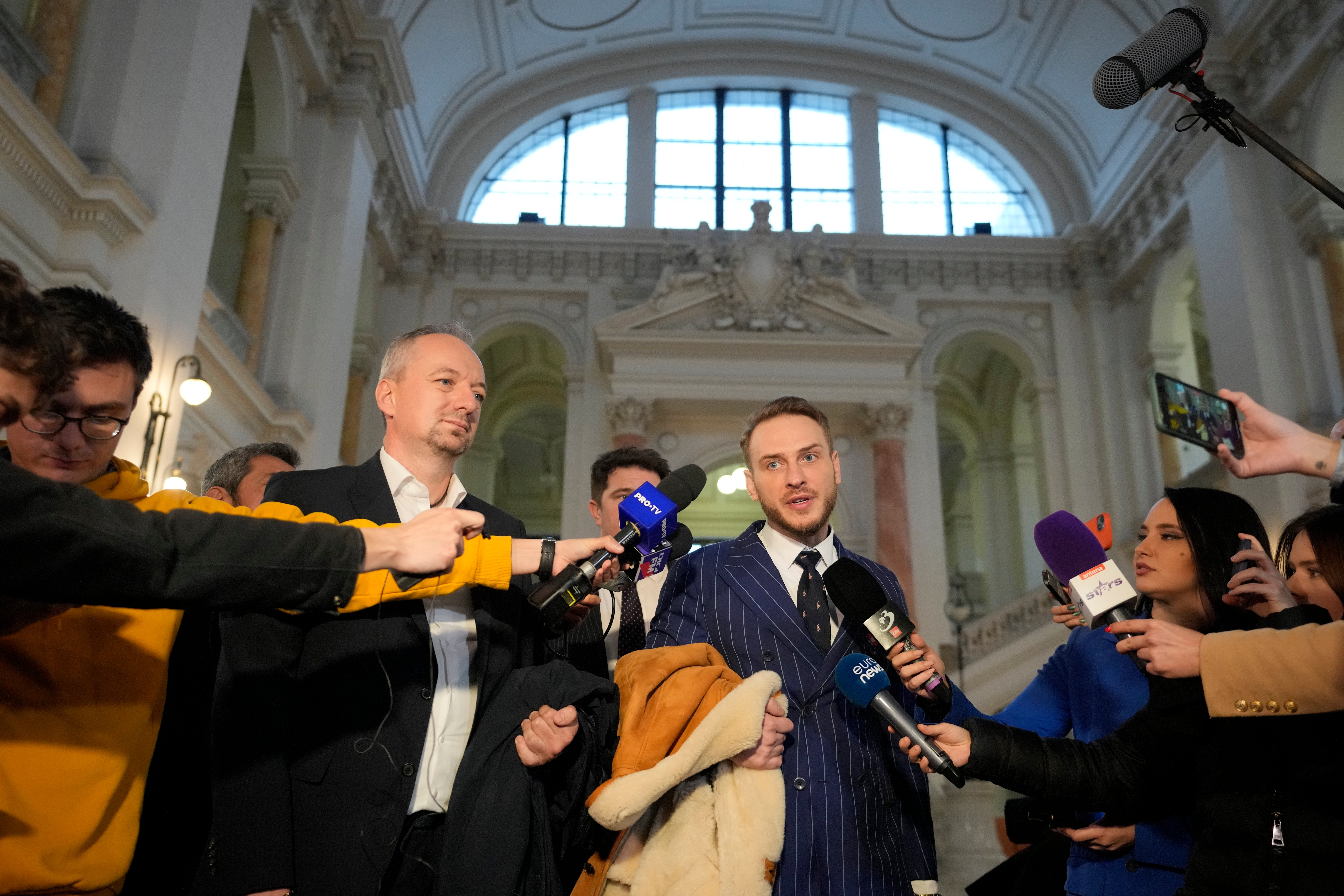 Lawyers Ioan Gliga, left, and Eugen Vidineac speak at the Court of Appeal in Bucharest