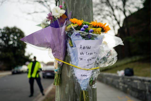 <p>Flowers are secured to a pole as a memorial to Karon Blake, 13, who died on Saturday </p>