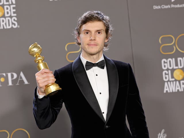 <p>Evan Peters with his Golden Globe trophy</p>