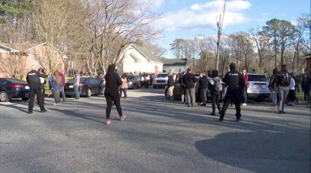 <p>People gather outside Richneck Elementary School, where according to the police, a six-year-old boy shot and wounded a teacher, in Newport News</p>