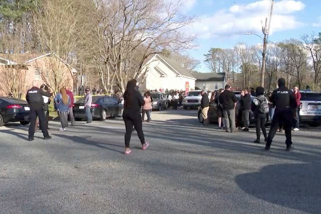 <p>People gather outside Richneck Elementary School, where according to the police, a six-year-old boy shot and wounded a teacher, in Newport News</p>