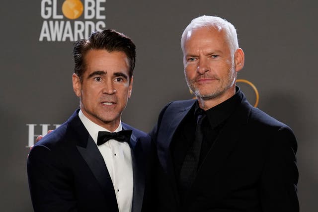 Colin Farrell, winner of the award for best performance by an actor in a motion picture, musical or comedy for The Banshees Of Inisherin, left, and Martin McDonagh, winner of the award for best screenplay, motion picture for The Banshees of Inisherin, pose in the press room at the 80th annual Golden Globe Awards at the Beverly Hilton Hotel (Chris Pizzello/Invision/AP/PA)