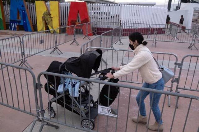 <p>Representative image: A woman pushing a baby stroller arrives at El Chaparral, or Ped West, crossing port at the Mexico-US border</p>