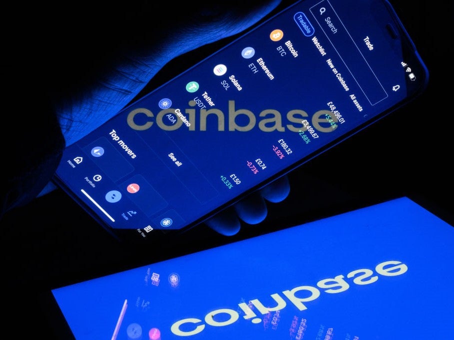 A flipped version of the logo for the crypto exchange Coinbase is reflected in a mobile phone screen on 9 November, 2021 in London, England