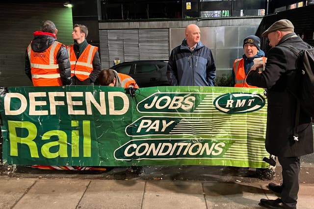 <p>Mick Lynch (centre), general secretary of the RMT union, on the picket line at Euston at the start of the January 2023 strikes</p>