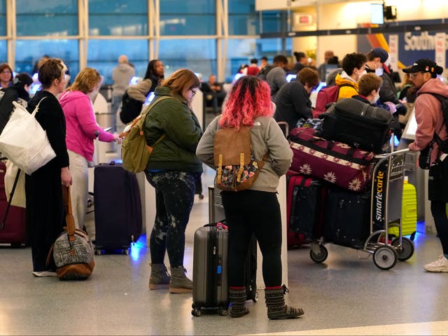 <p>Passengers check in at Southwest Airlines' self serve kiosks at Chicago's Midway Airport as flight delays stemming from a computer outage at the Federal Aviation Administration </p>