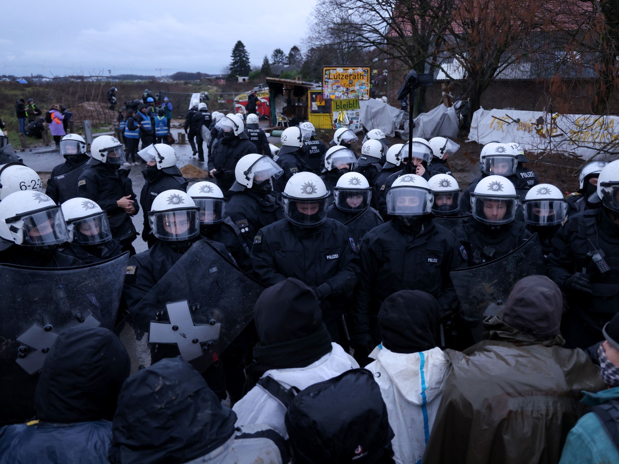 Activists line up against riot police