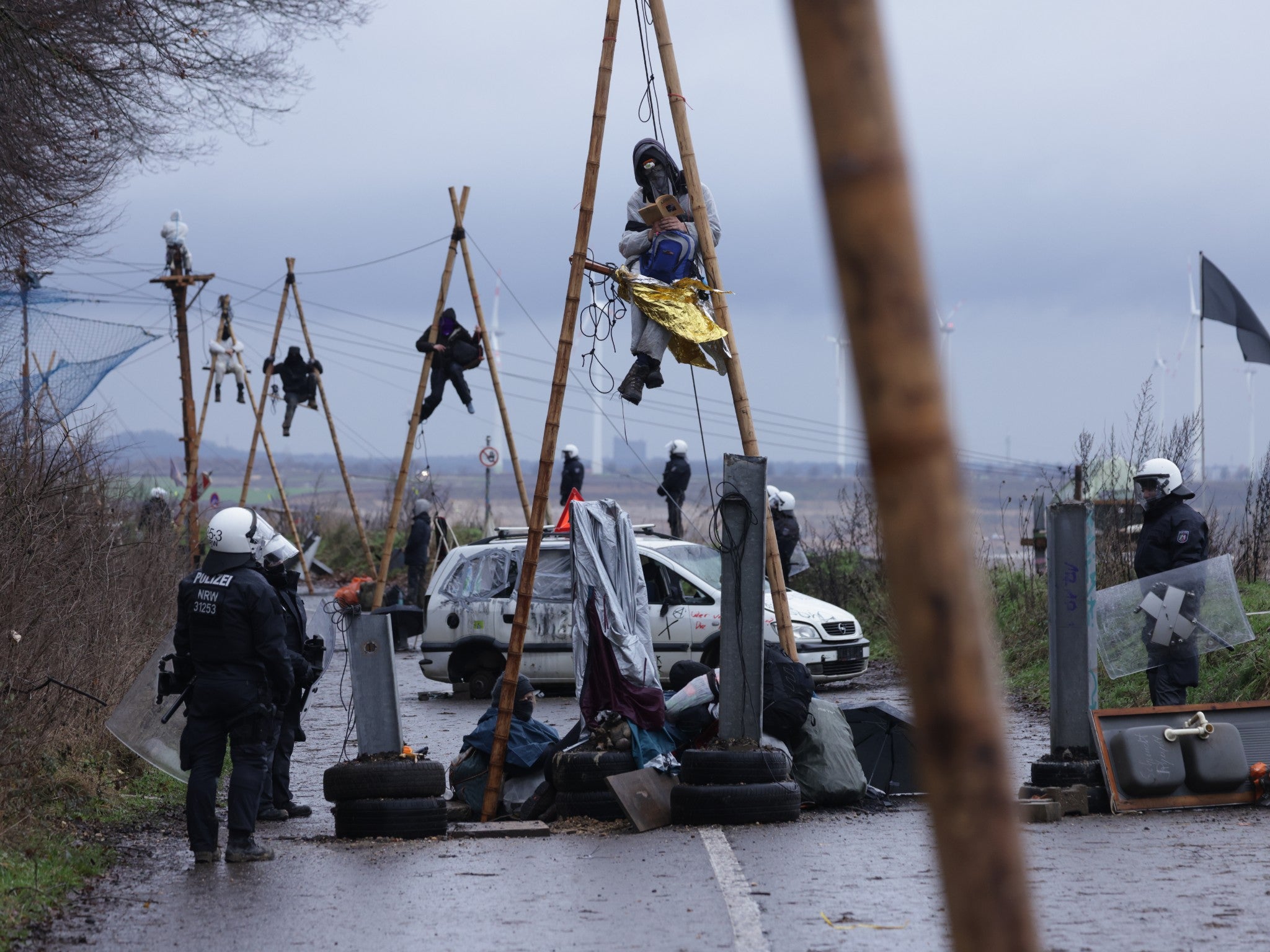 Activists suspended themselves on wooden frames