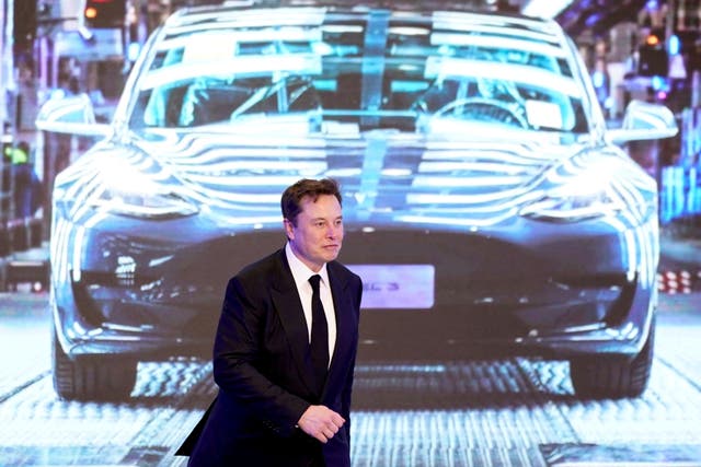 <p>Tesla Inc CEO Elon Musk walks next to a screen showing an image of Tesla Model 3 car during an opening ceremony for Tesla China-made Model Y program in Shanghai, China 7 January 2020 </p>