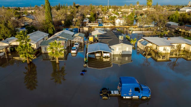 <p>Following days of rain, floodwaters surround homes and vehicles in the Planada community of Merced County, Calif., on Tuesday, Jan. 10, 2023</p>