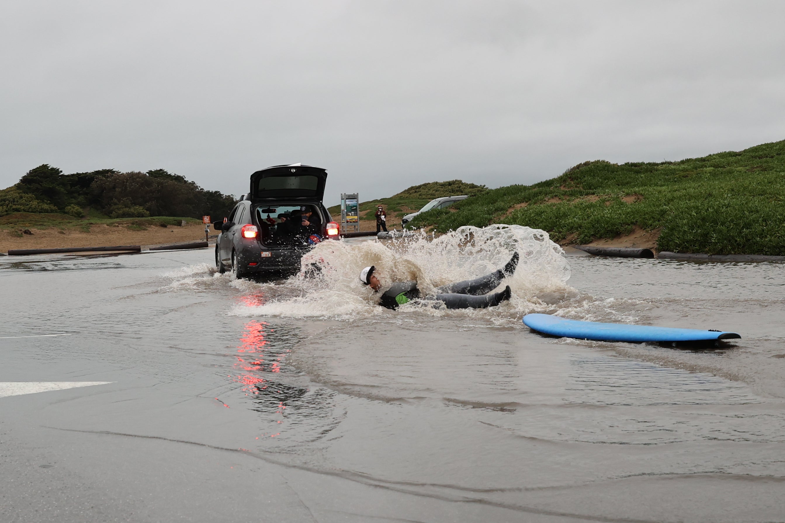 Jose Martin surfs in a flood at Fort Funston in San Francisco