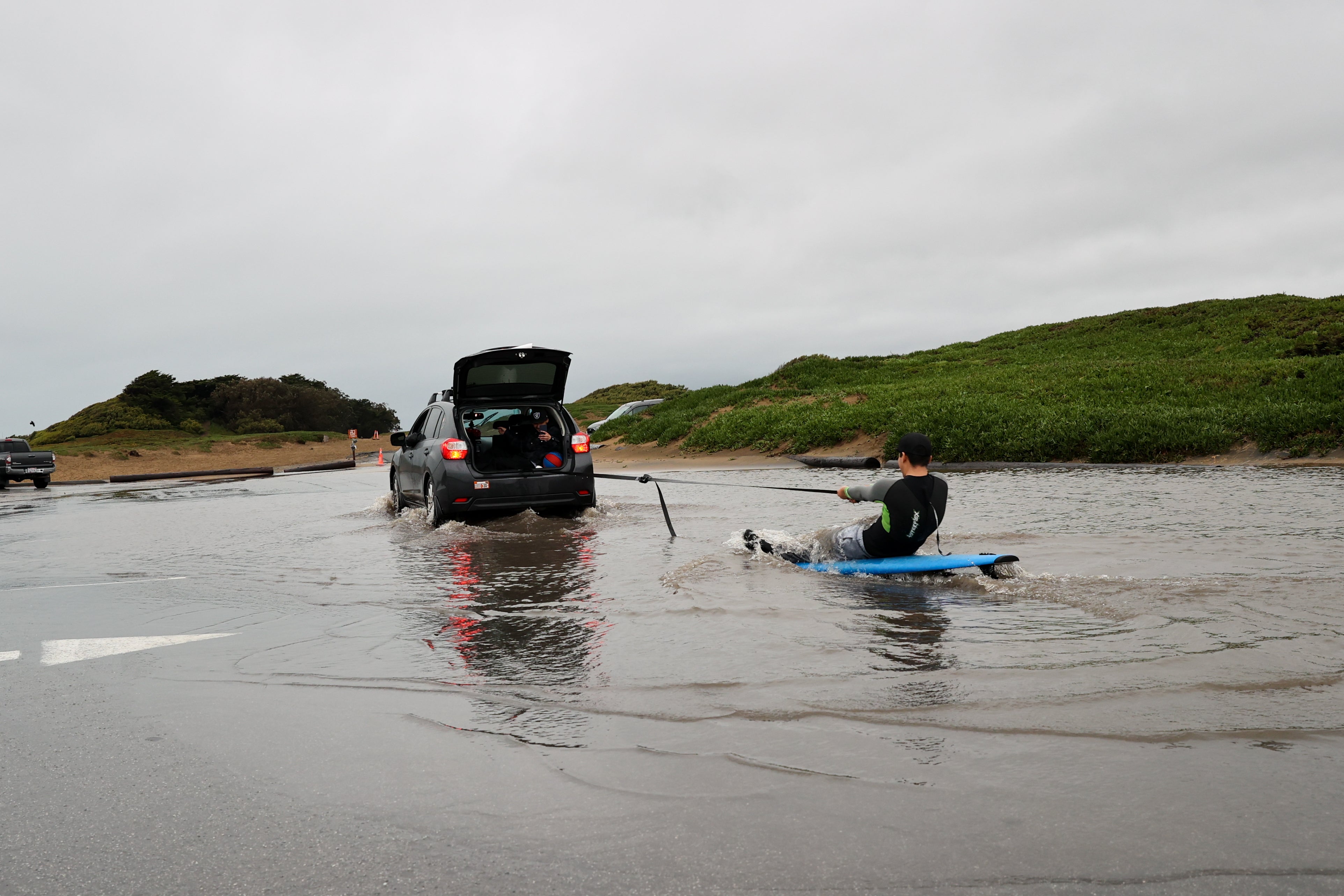 Jose Martin surfs in a flood at Fort Funston in San Francisco