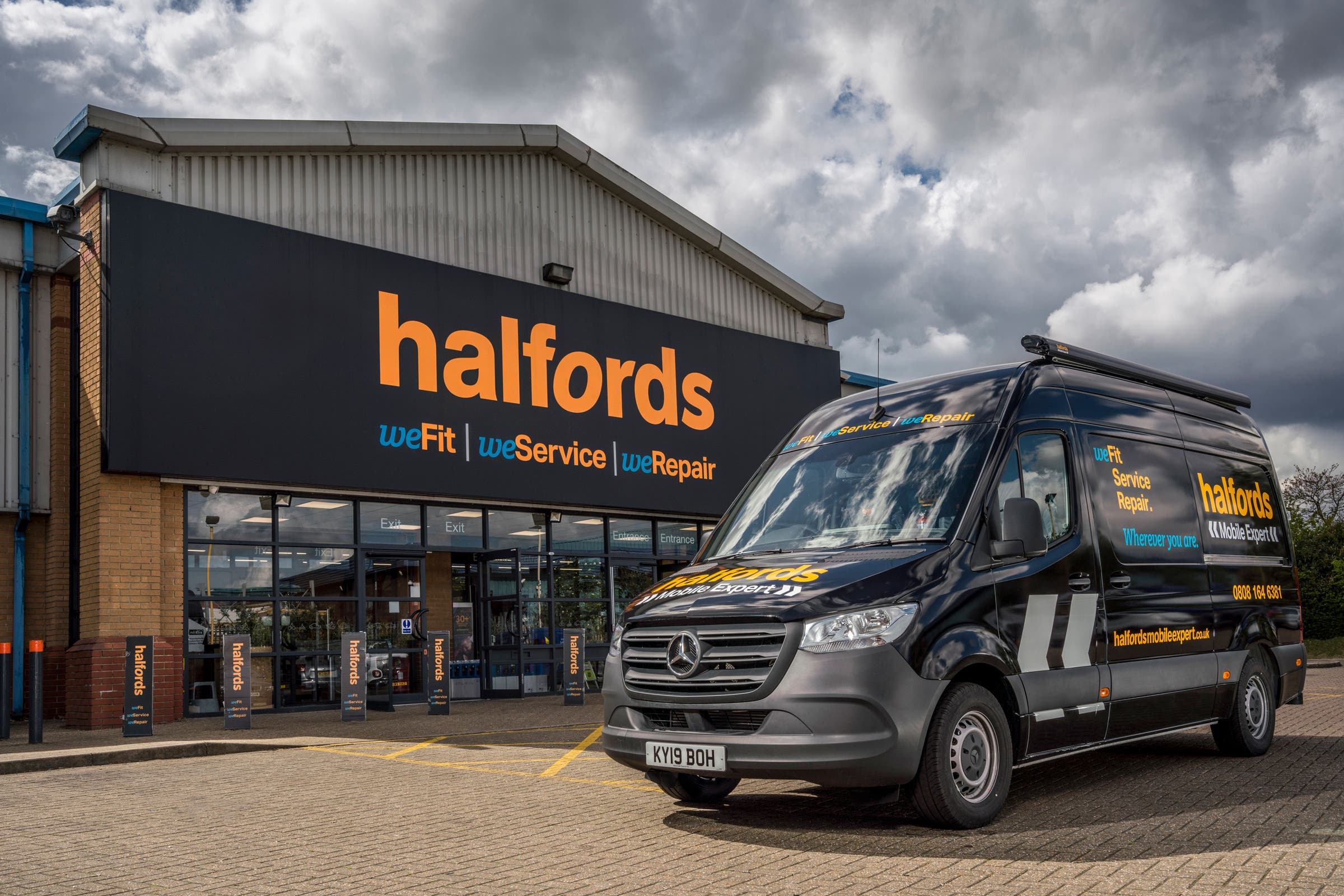 Undated handout photo issued by Halfords of a store front and a mobile expert van (Halford/PA)