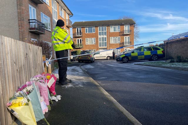 Several bunches of flowers were left beside the police cordon outside Petherton Court, alongside cuddly toys (Joe Giddens/PA)