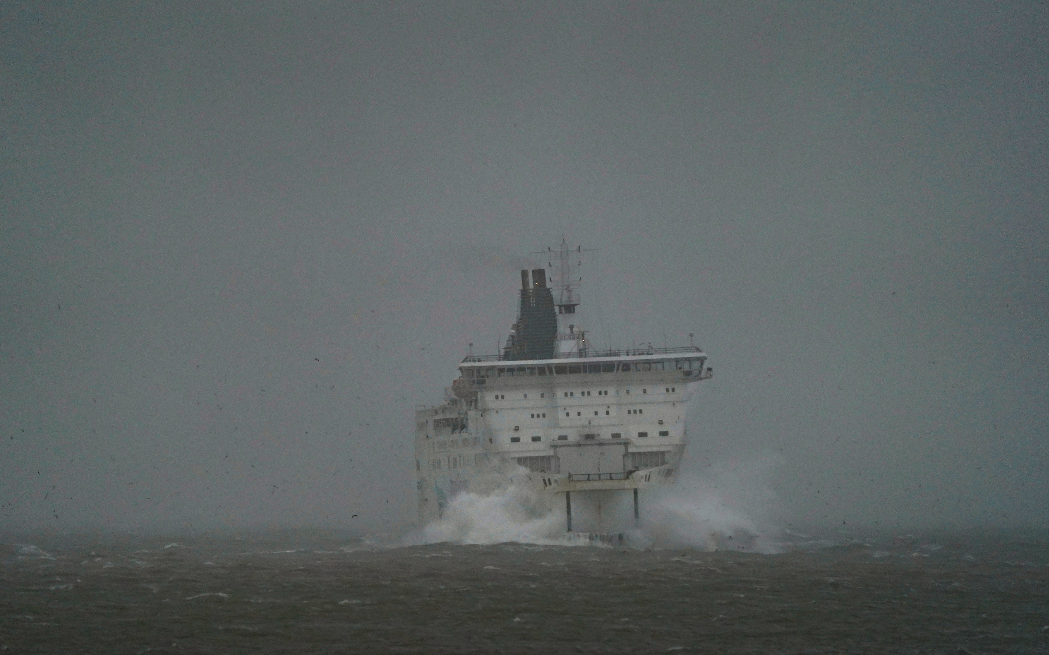 A DFDS ferry makes its way through choppy waters at Port of Dover in Kent