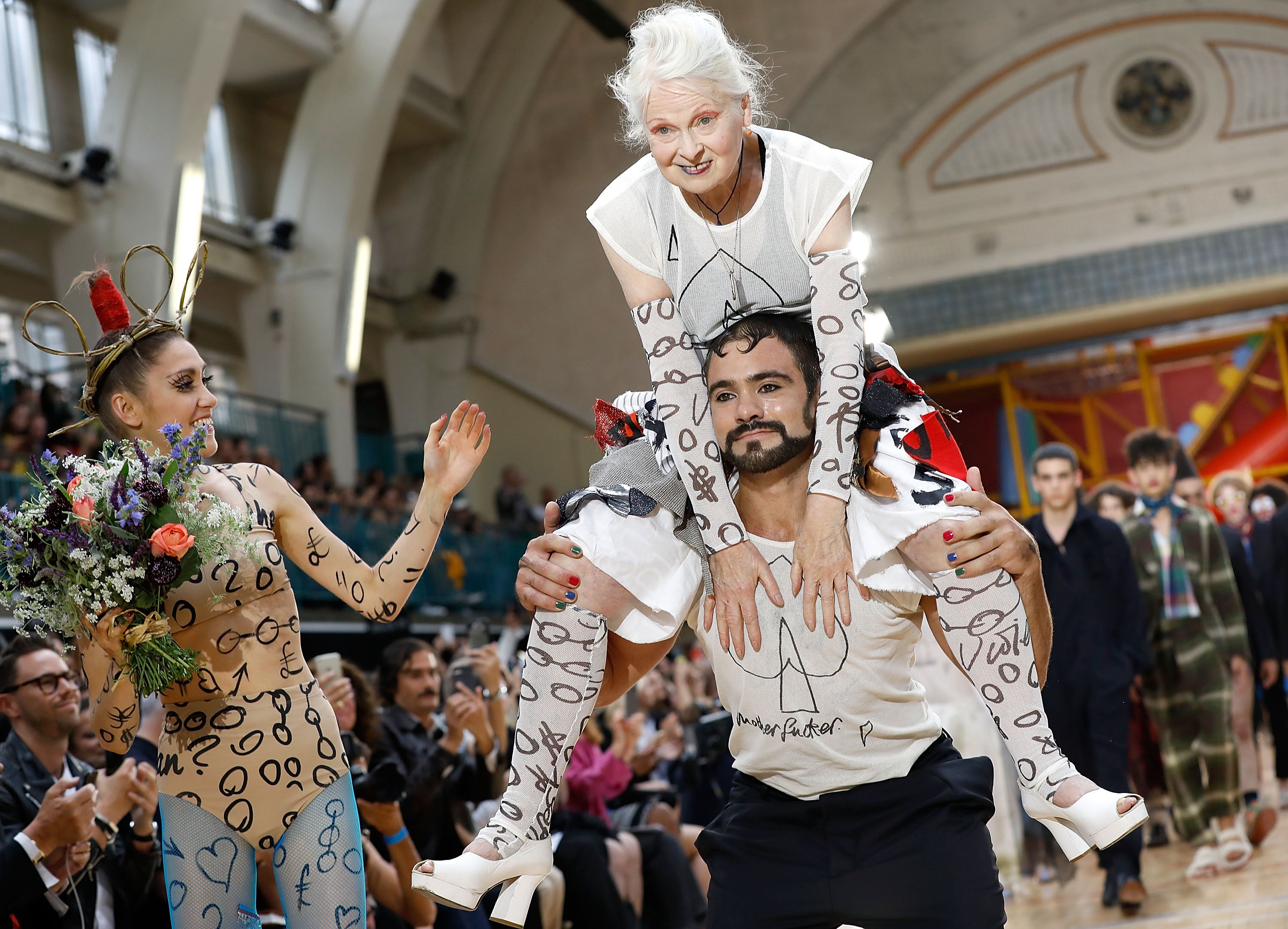 On top: Westwood gets a lift down the runway at Men’s London Fashion Week in June 2017