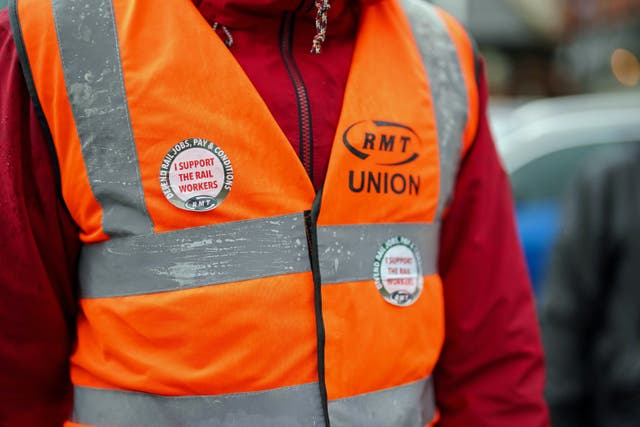 A member of the Rail, Maritime and Transport union (RMT) on the picket line outside New Street station in Birmingham (Jacob King/PA)