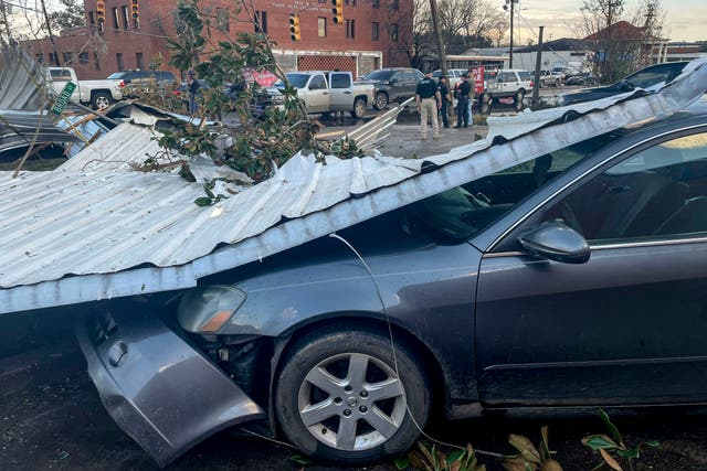 <p>A damaged vehicle and debris are seen in the aftermath of severe weather, Thursday</p>