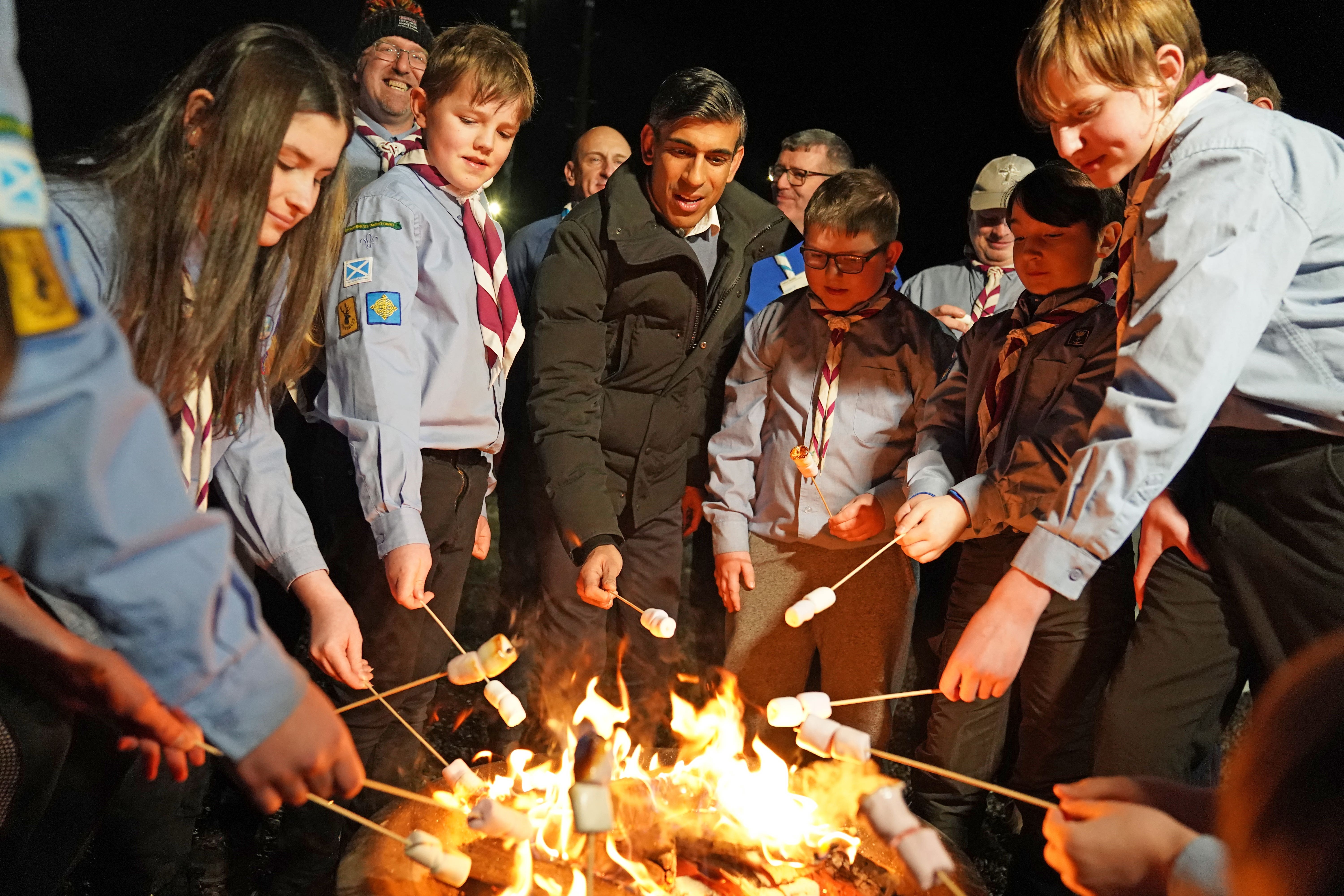 Rishi Sunak toasts marshmallows with a group of Sea scouts in Muirtown, Inverness, as part of his trip to Scotland (Andrew Milligan/PA)