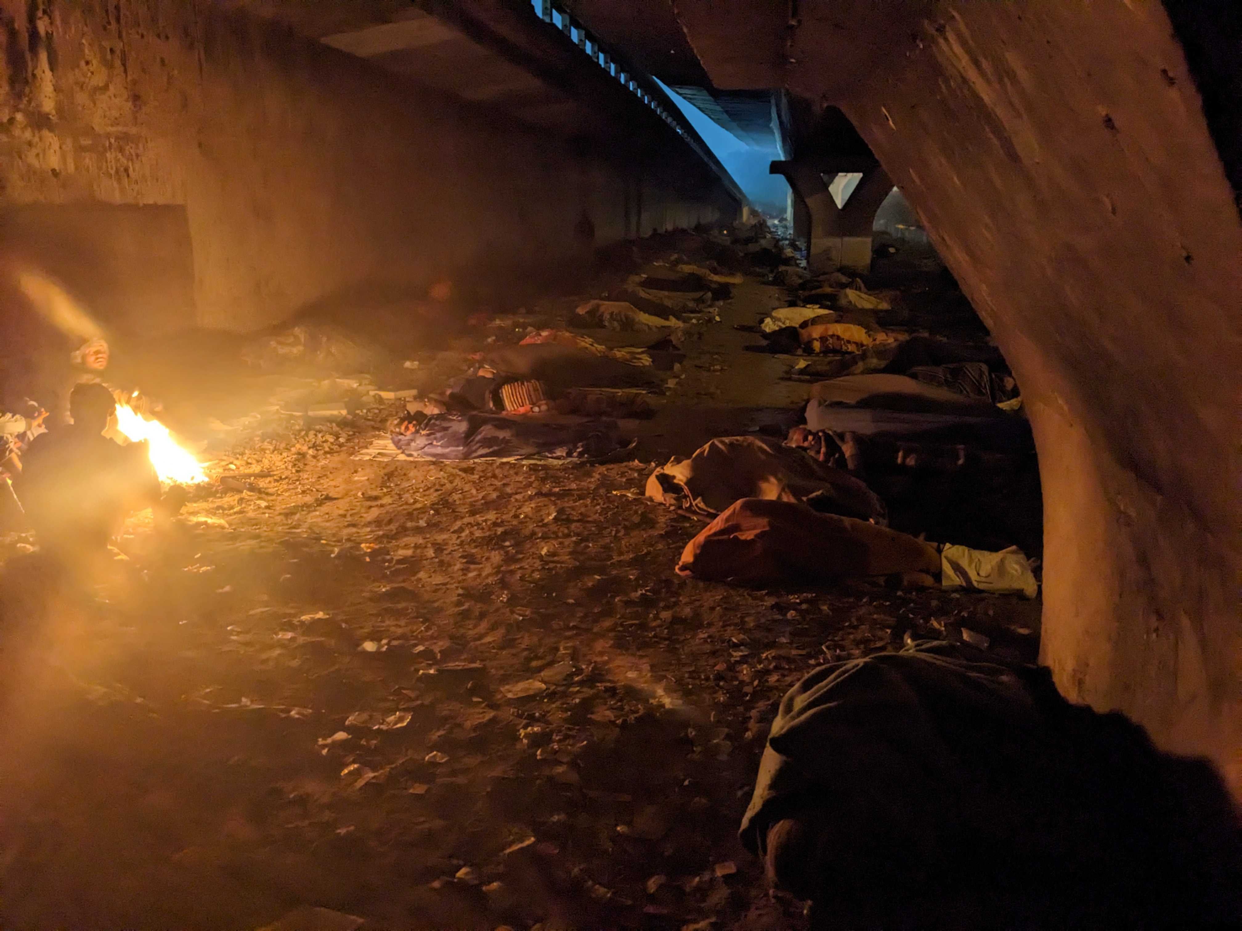 Hundreds of homeless people sleep under a flyover in central Delhi as the mercury drops to 3C