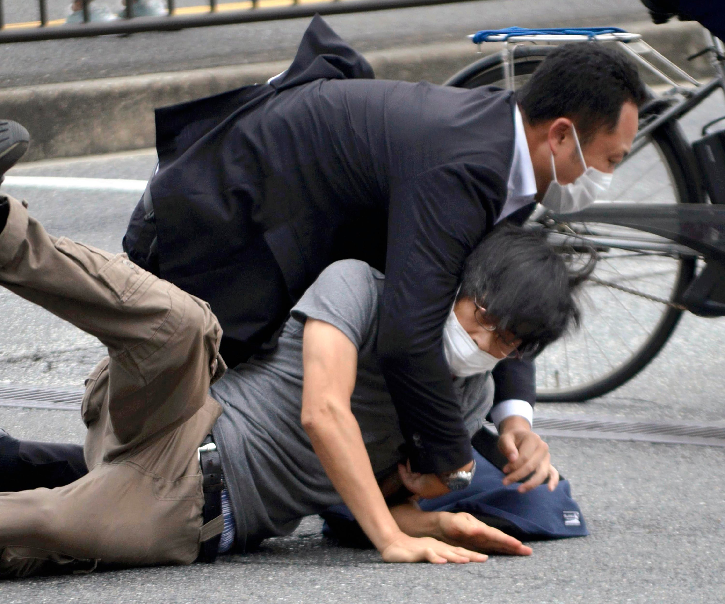 File photo: Tetsuya Yamagami is detained near the site of gunshots in Nara Prefecture in western Japan on 8 July 2022. Japanese prosecutors formally charged the suspect in the assassination of former prime minister Shinzo Abe with murder, Japan’s NHK public television reported Friday, 13 January 2023