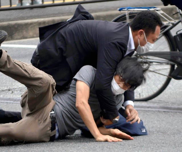 <p>File photo: Tetsuya Yamagami is detained near the site of gunshots in Nara Prefecture in western Japan on 8 July 2022. Japanese prosecutors formally charged the suspect in the assassination of former prime minister Shinzo Abe with murder, Japan’s NHK public television reported Friday, 13 January 2023</p>