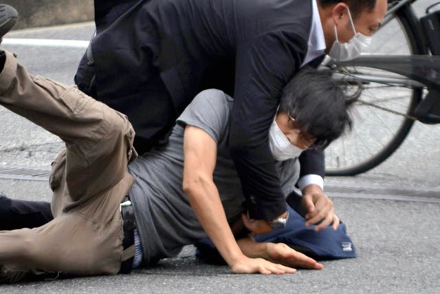 <p>File photo: Tetsuya Yamagami is detained near the site of gunshots in Nara Prefecture in western Japan on 8 July 2022. Japanese prosecutors formally charged the suspect in the assassination of former prime minister Shinzo Abe with murder, Japan’s NHK public television reported Friday, 13 January 2023</p>