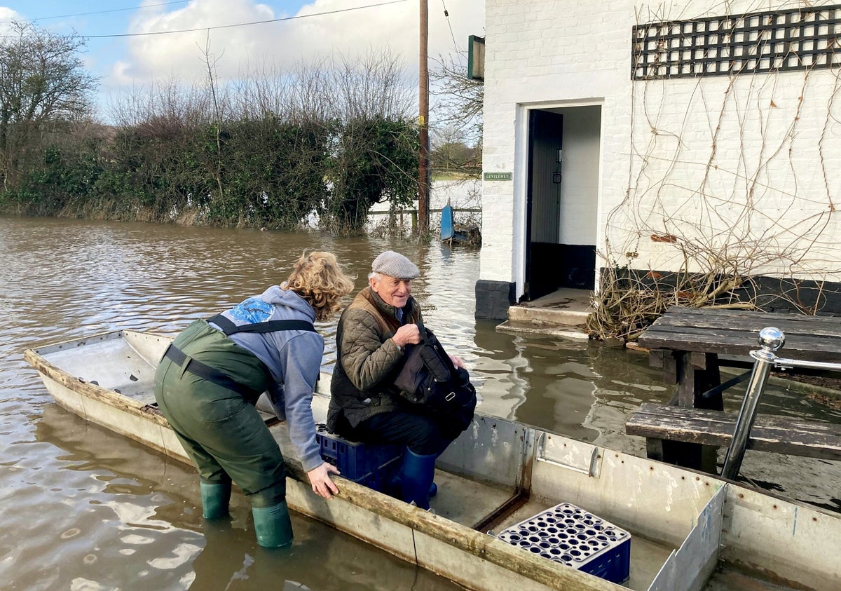 Villagers ferried to pub by boat after floods submerge path