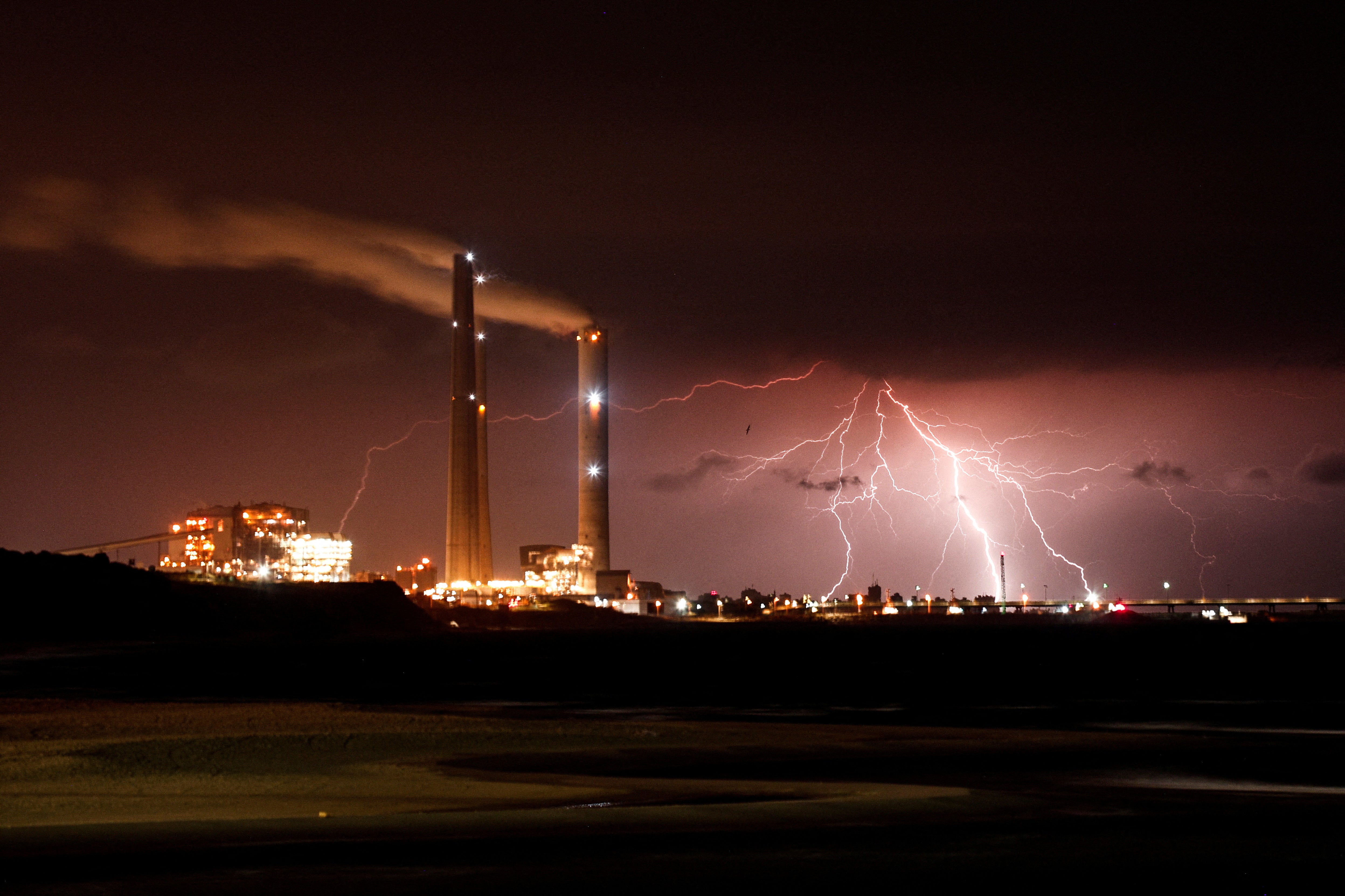 Rutenberg power station is seen as lightning strikes over the Mediterranean sea at the coastal city of Ashkelon, Israel