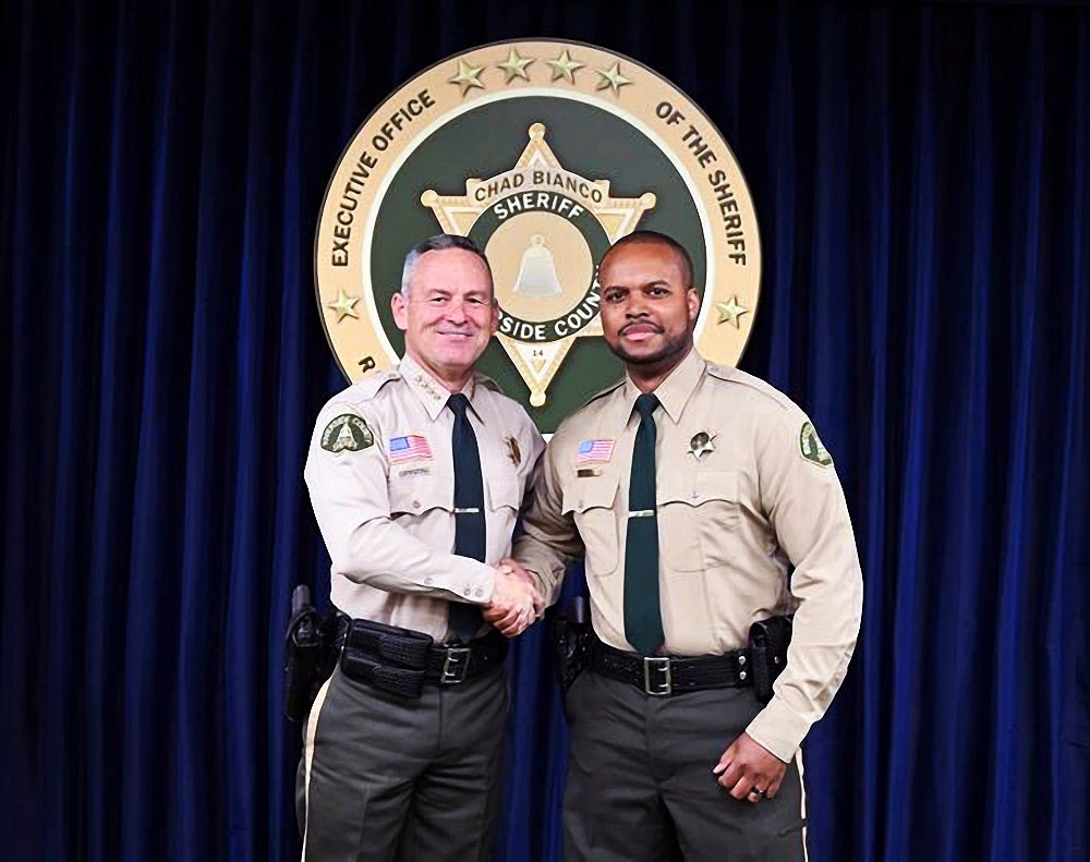 Deputy Darnell Calhoun, right, poses with Riverside County Sheriff Chad Biano