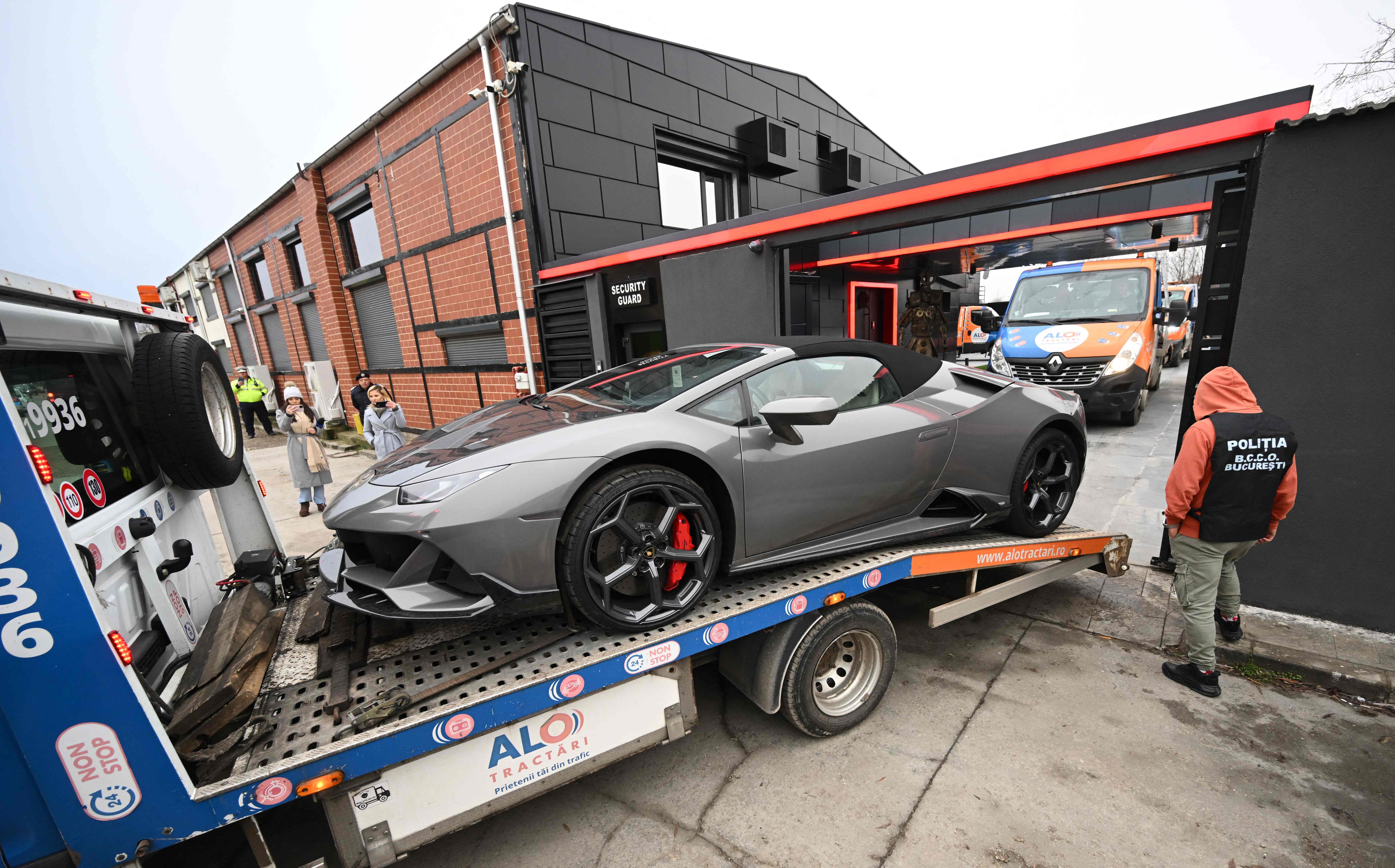 One of Andrew Tate’s many luxury cars is loaded onto a flatbed and taken away