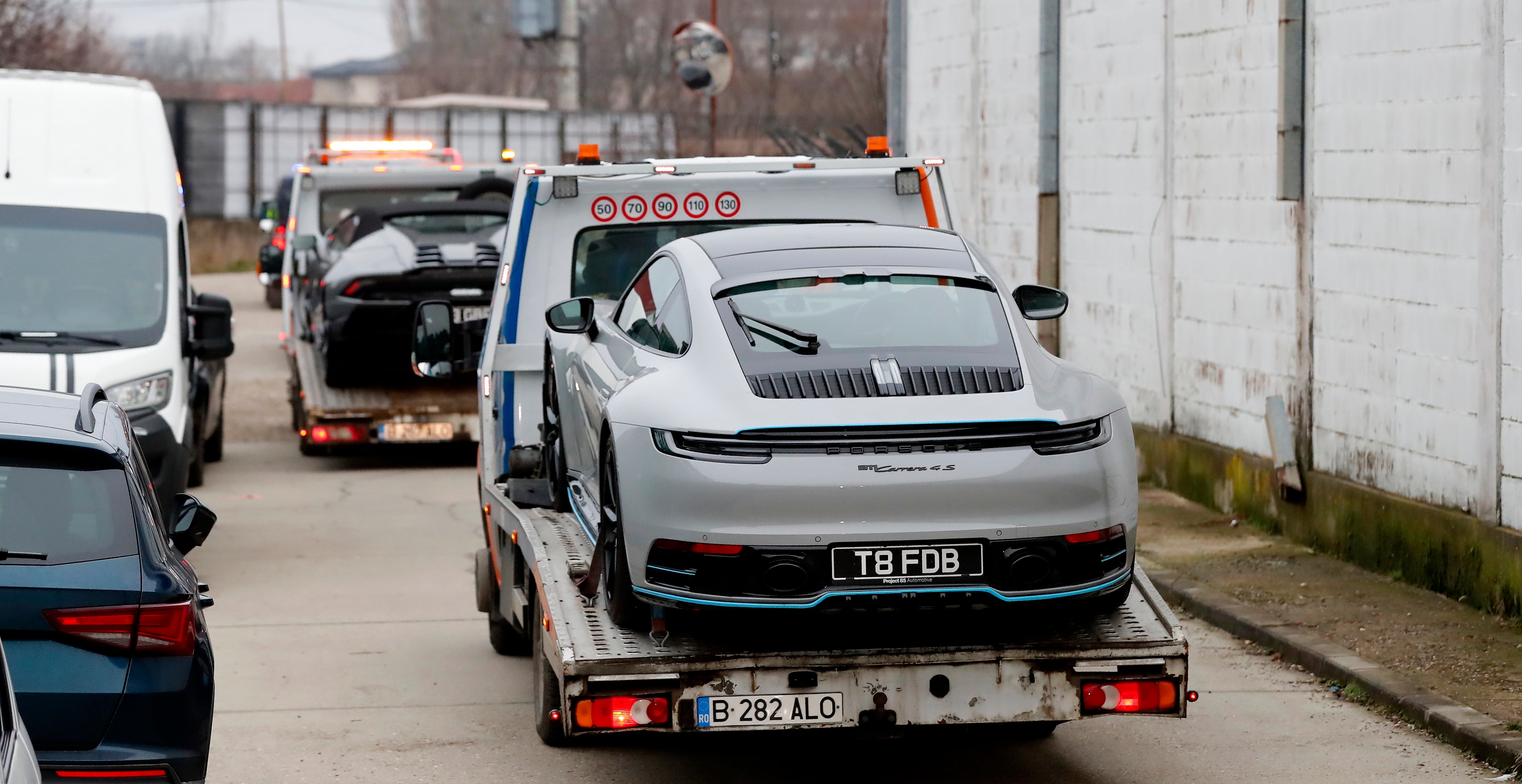 A grey Porsche Carrera owned by Andrew Tate is removed by officials