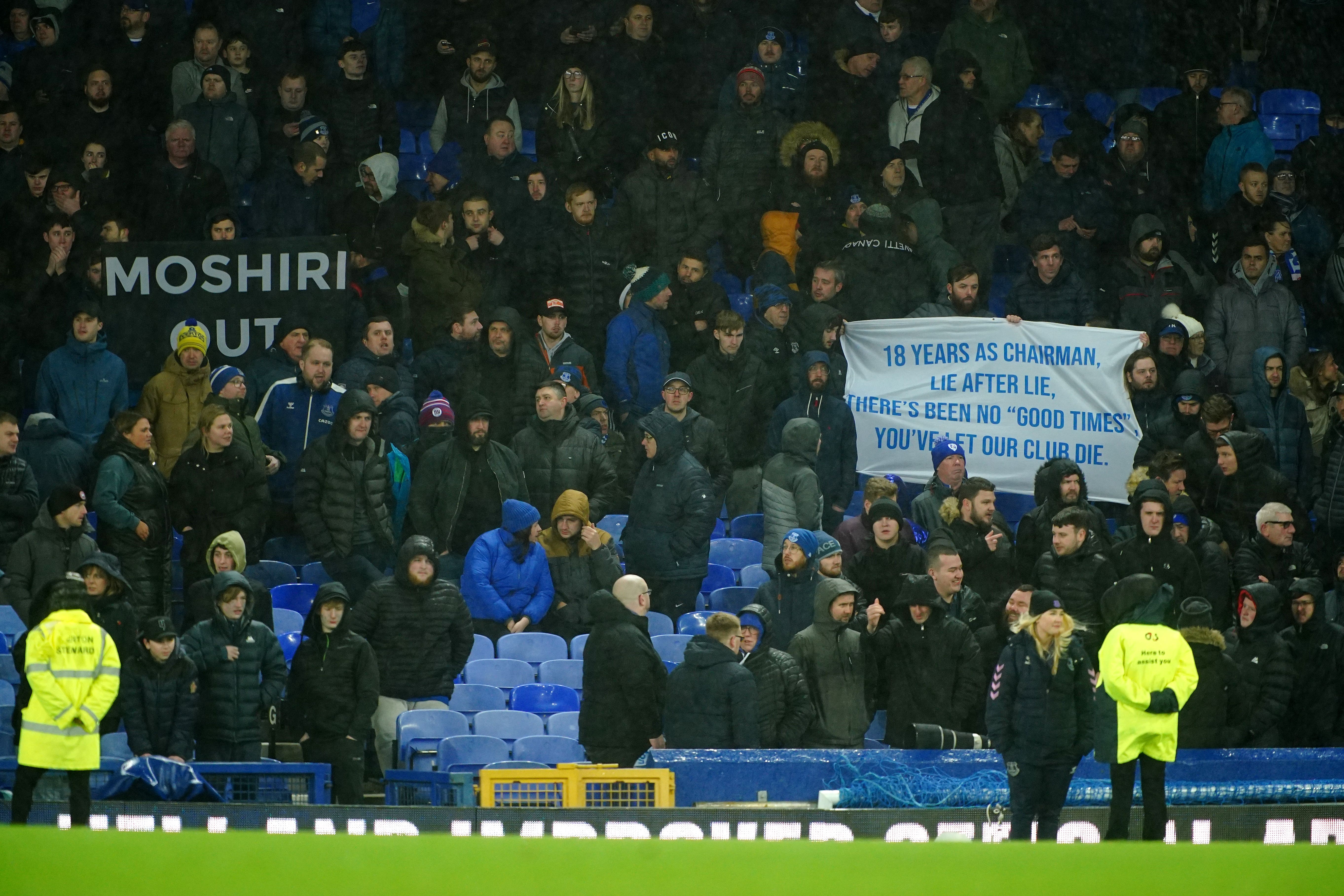 Everton fans hold up banners in protest against the club’s board (Peter Byrne/PA)