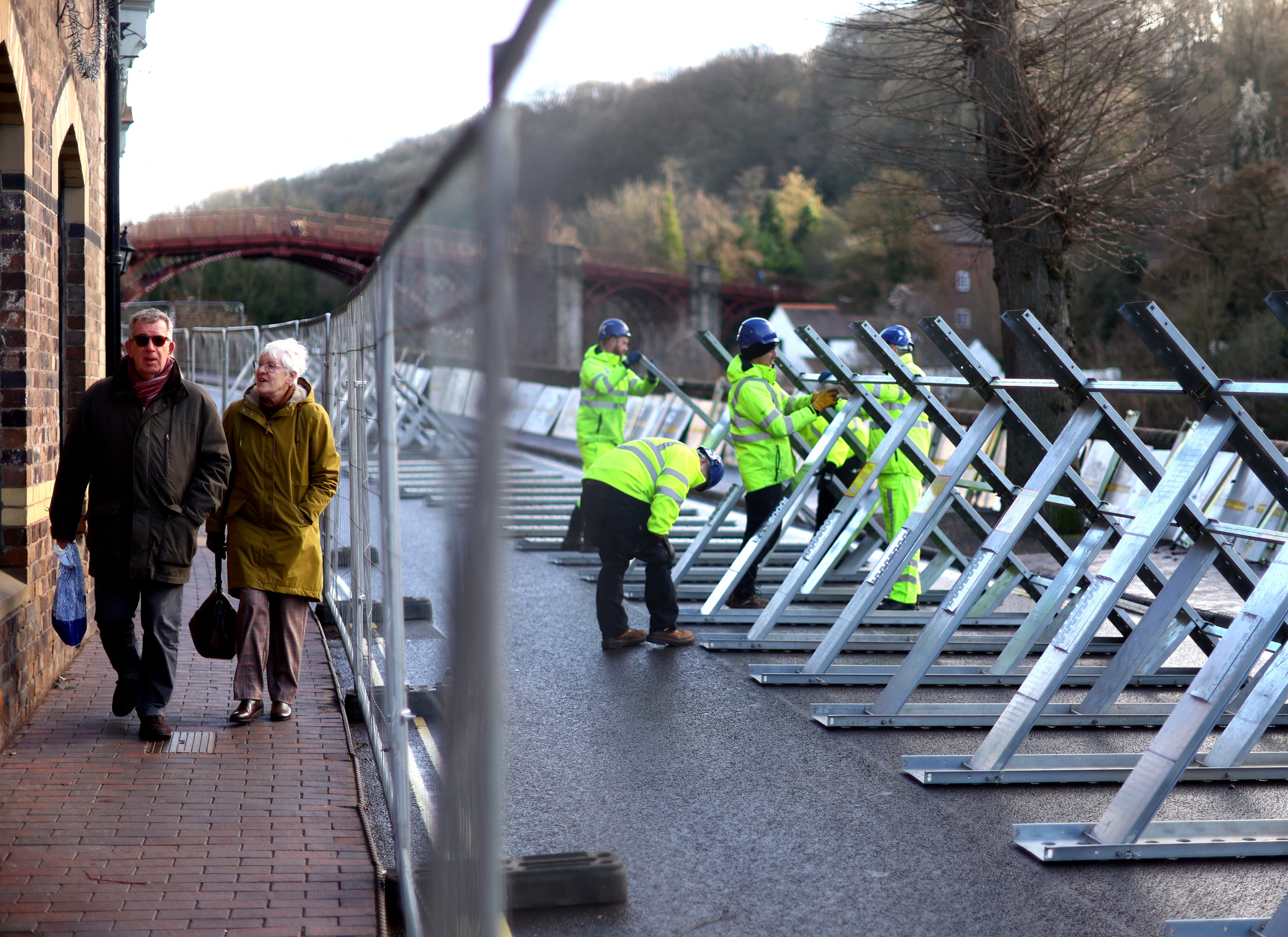 Environment Agency workers erect flood barriers earlier this week to protect property by the River Severn in Ironbridge, Shropshire
