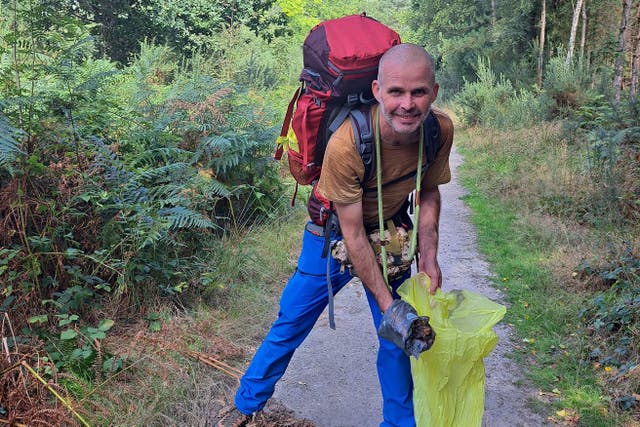 Charity hiker Henry Rawlings collected more than 88lb of dog poo during a 65-mile sponsored walk in the South Downs National Park in a bid to help protect the fragile wildlife haven (South Downs National Park/PA)