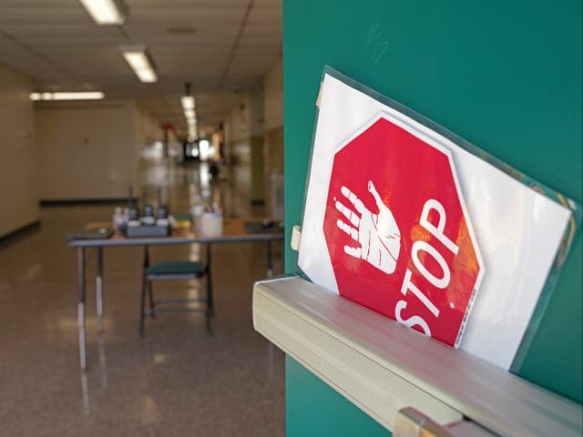 <p>A side door warns visitors to stop at Richneck Elementary School on January 7, 2023 in Newport News, Virginia</p>