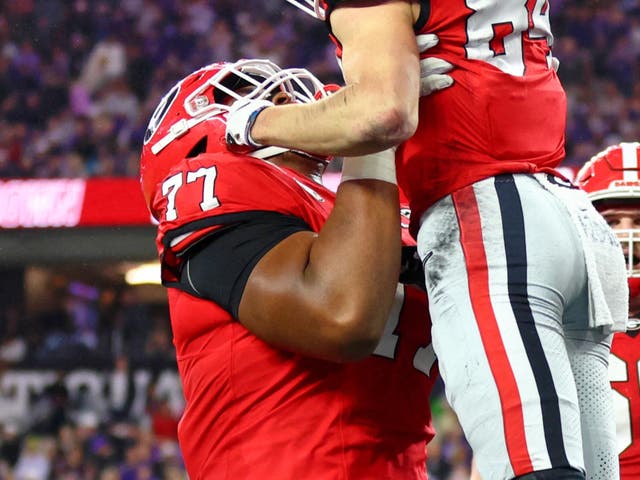 <p>Georgia Bulldogs offensive lineman Devin Willock (77) lifts up wide receiver Ladd McConkey (84) after he scored a touchdown</p>