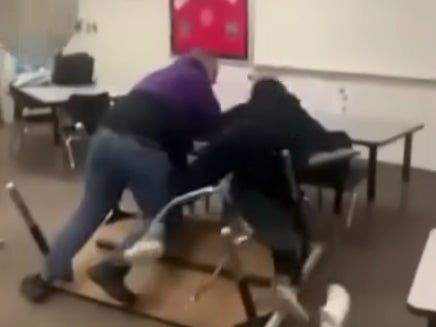 A teacher has been placed on leave after a shocking video showed him slamming a student into a wall