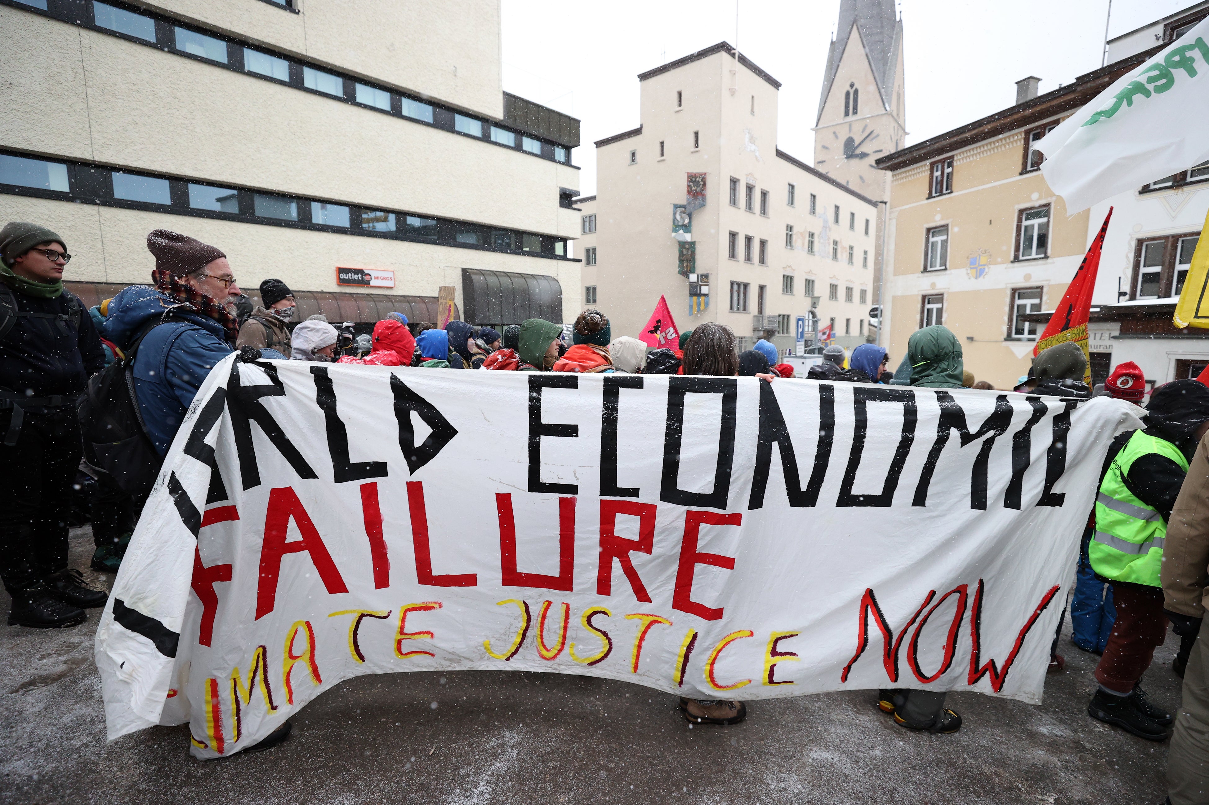 Activists take part in a protest in Davos on Sunday to raise awareness on climate change prior to the WEF annual meeting